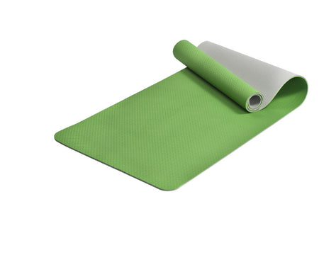 Green yoga mat with a white backing on a white background