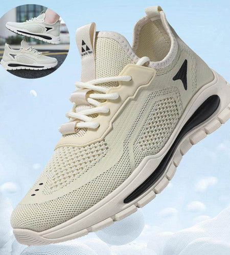 Beige running shoe with black accents on a light blue background