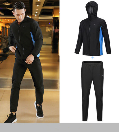 Person wearing a black tracksuit with blue accents in a gym setting, with an inset showing the tracksuit components.
