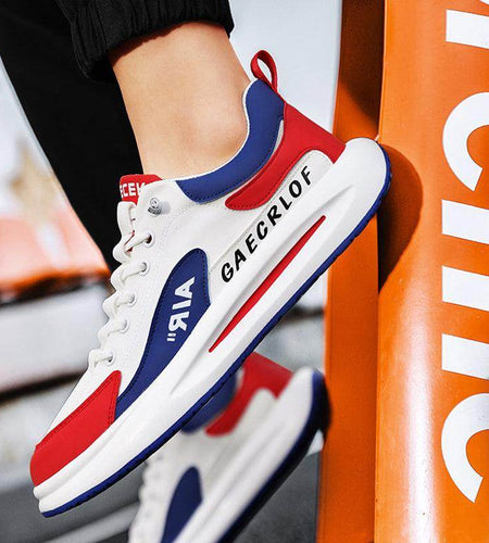 White, red, and blue sneakers with 'GAECRLOF' branding against an orange background.