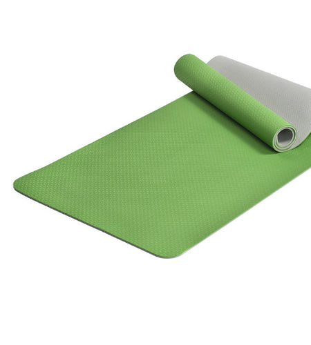 Green yoga mat with a white backing on a white background