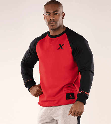 Man wearing a red and black long-sleeve shirt with a logo on a white background