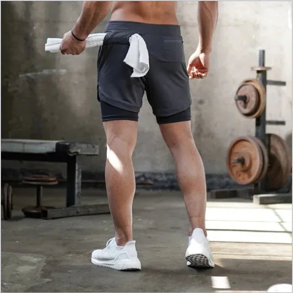 Person wearing dark shorts in a gym setting