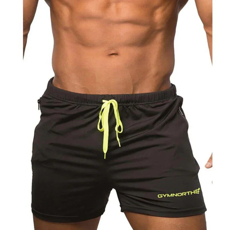 Black shorts with yellow drawstring and branding on a white background
