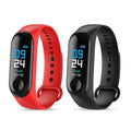 Two fitness trackers, one red and one black, on a white background