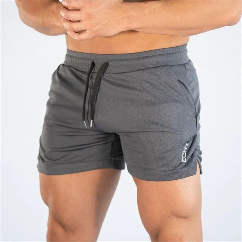 Gray athletic shorts with a drawstring on a white background