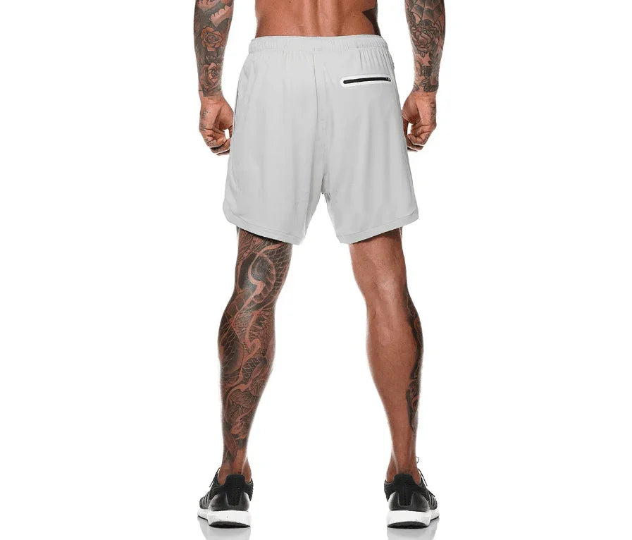 Person wearing light gray athletic shorts on a white background