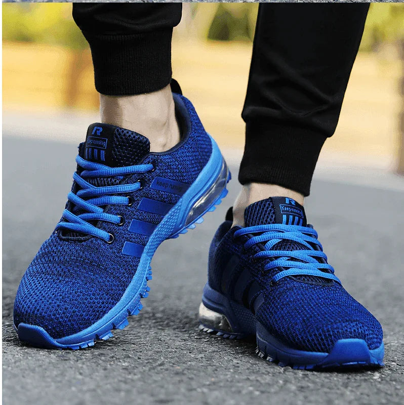 Blue running shoes worn on a road with a blurred background