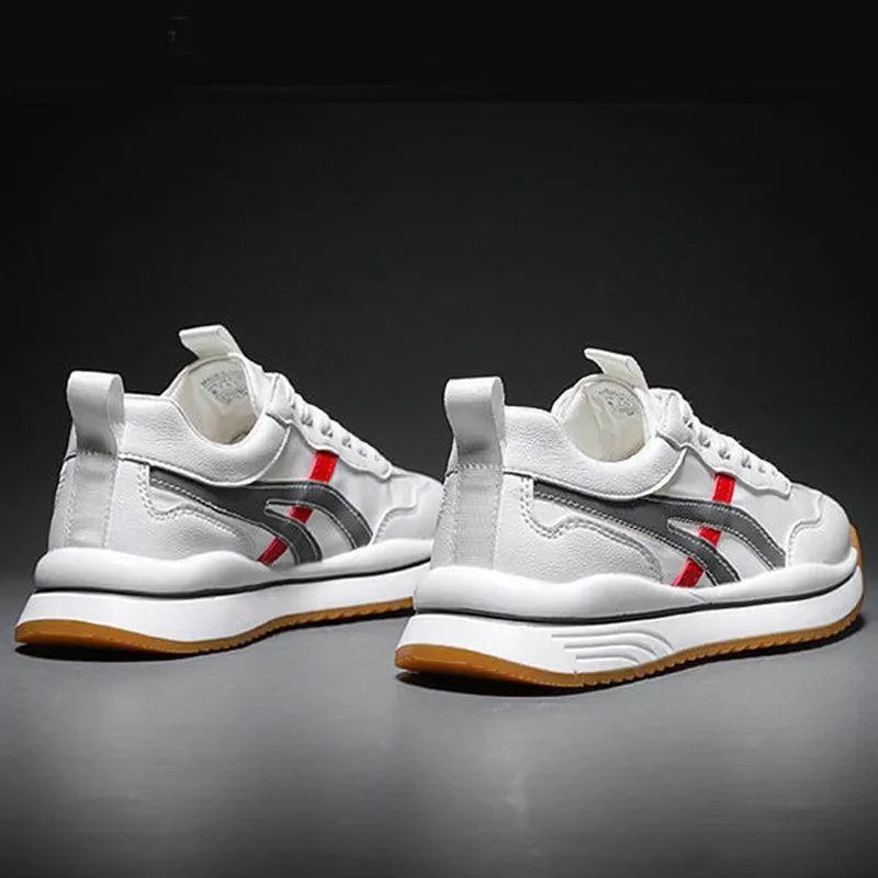 White sneakers with red and gray accents on a dark background