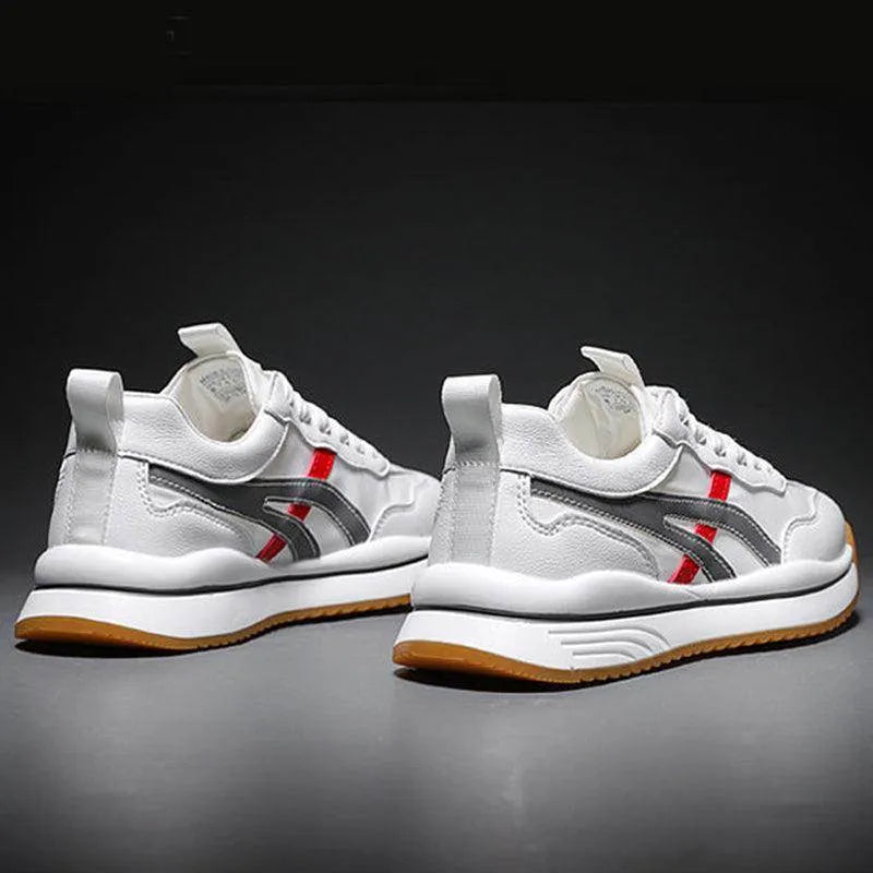 White sneakers with red and gray accents on a dark background