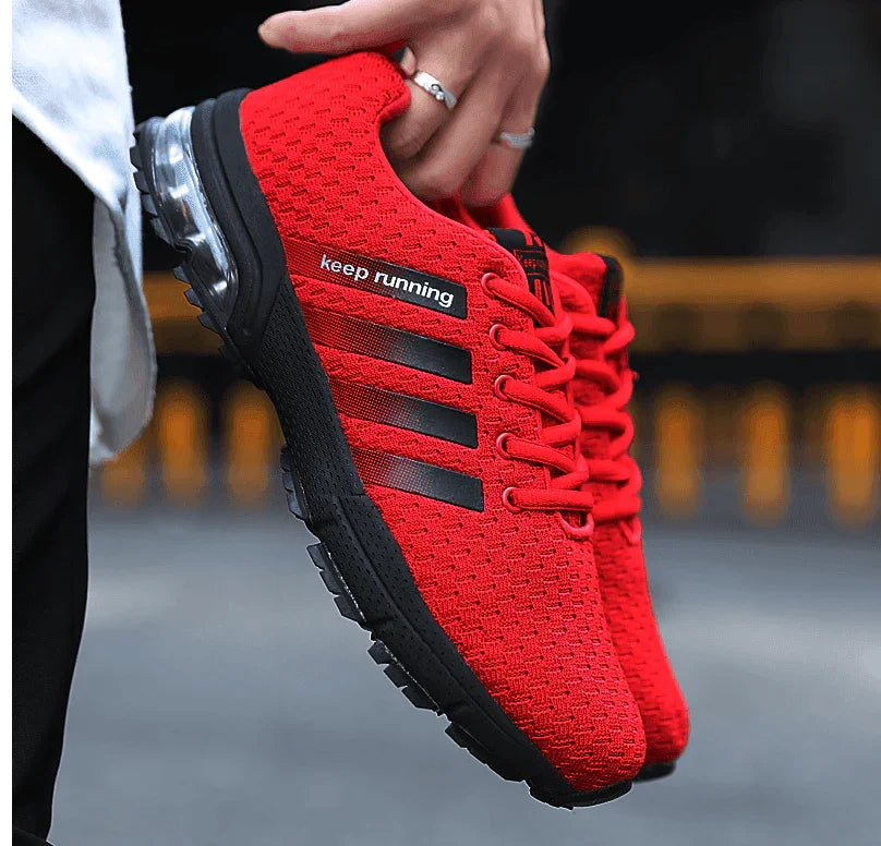 Red running shoe with 'keep running' text and Adidas logo held by a person.