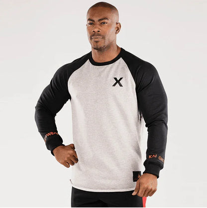 Man wearing a black and gray long-sleeve shirt with a logo on a white background