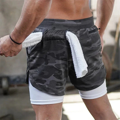 Person wearing camouflage shorts with a white towel, outdoor setting