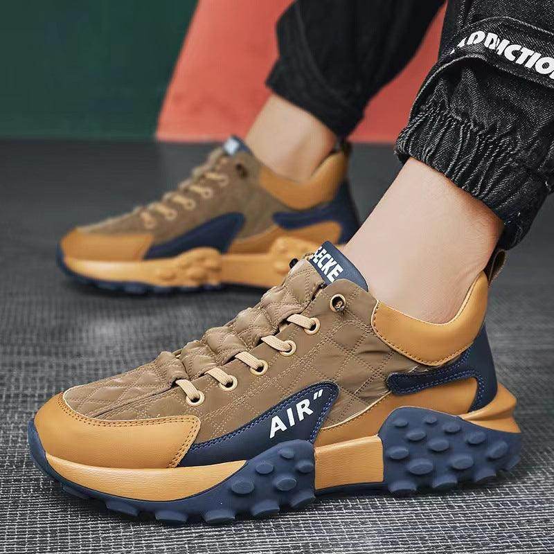 Brown and blue sneakers with 'Air' branding on a textured surface.