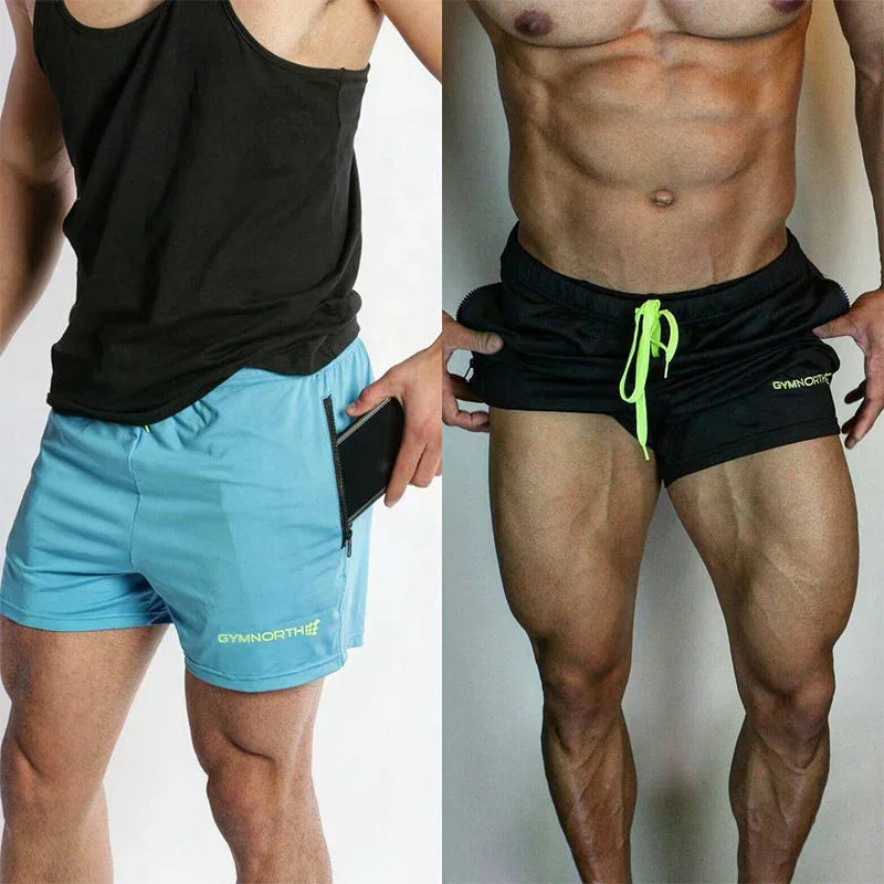Two sets of athletic shorts, one black and blue, the other black with a green drawstring, on a plain background.