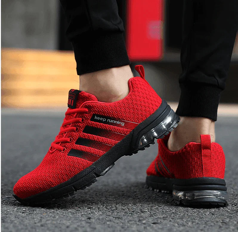 Red running shoes with black soles on a blurred background