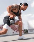 Man exercising with a kettlebell outdoors
