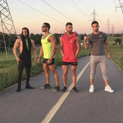 Four men in athletic wear standing on a road with power lines in the background