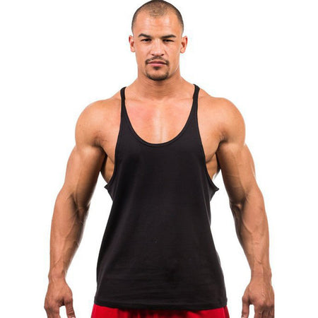 Man wearing a black tank top and red shorts on a white background
