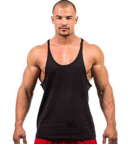 Man wearing a black tank top and red shorts on a white background