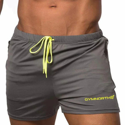Gray shorts with yellow drawstring and branding on a white background