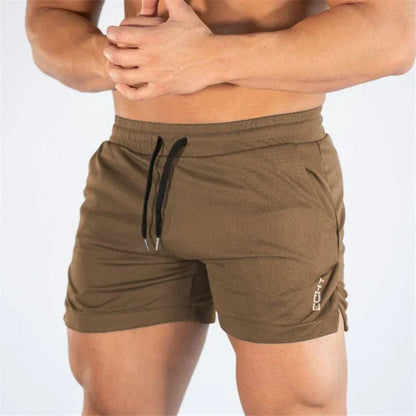 Brown athletic shorts with a drawstring on a white background