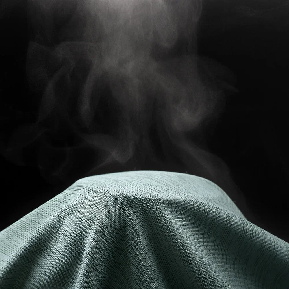 Green fabric with smoke effect on a black background