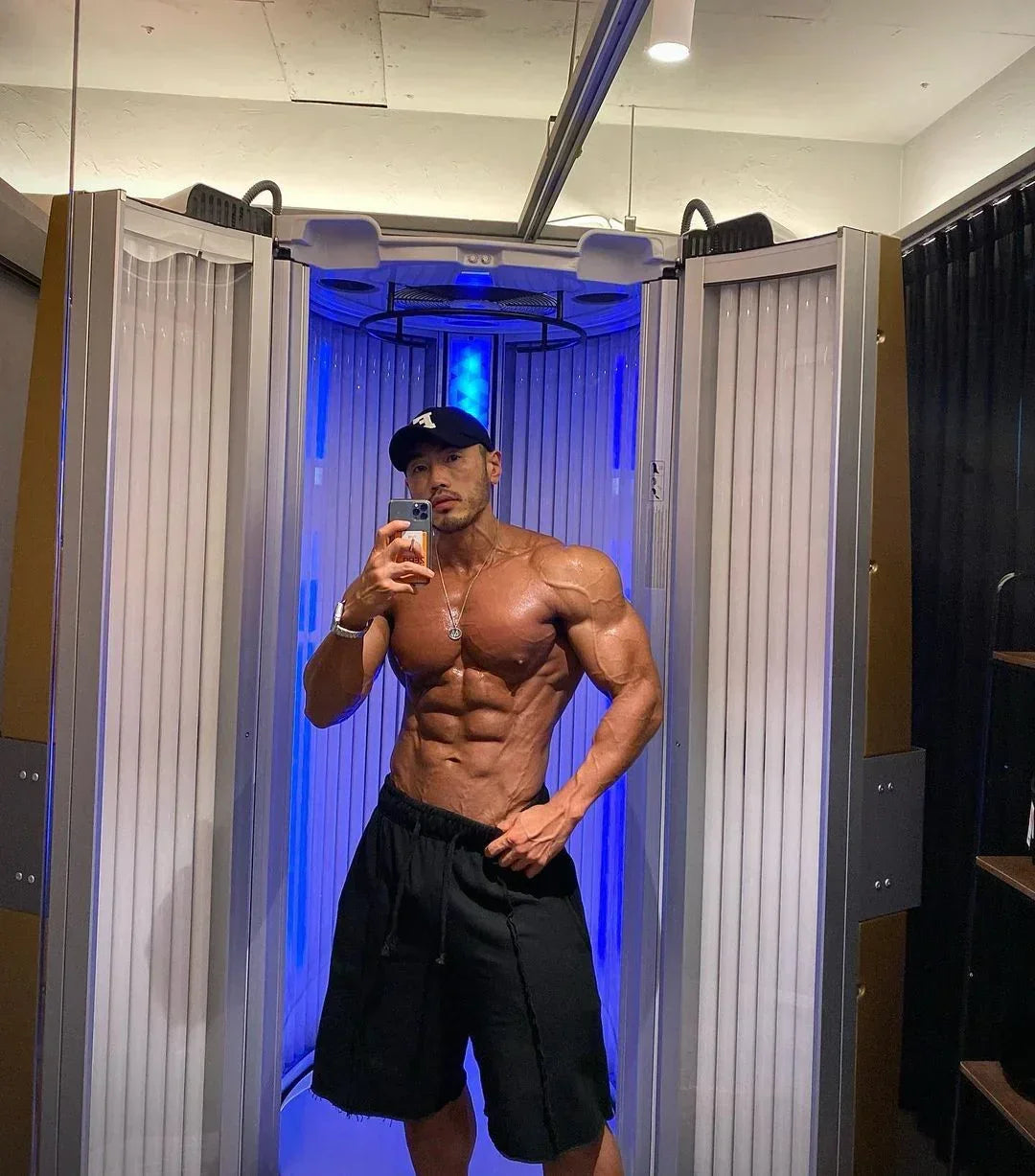Man taking a mirror selfie in an infrared sauna