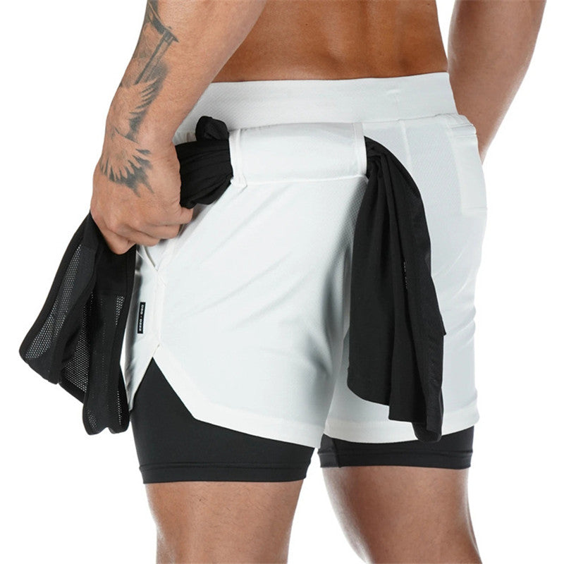 White athletic shorts with black accents worn by a person on a white background