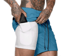 Person wearing a blue and white athletic outfit with tattoos on arms and legs.