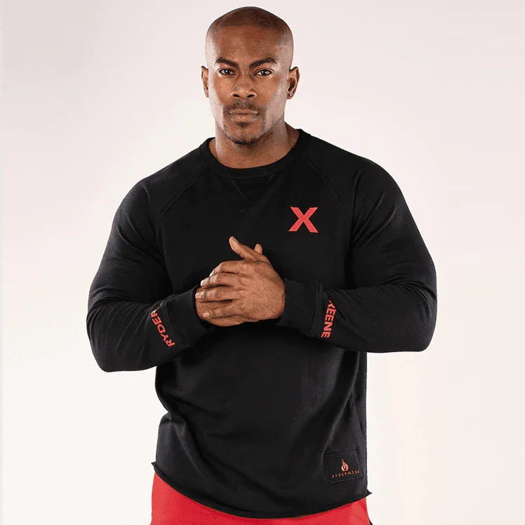 Man wearing a black long-sleeve shirt with red accents on a white background
