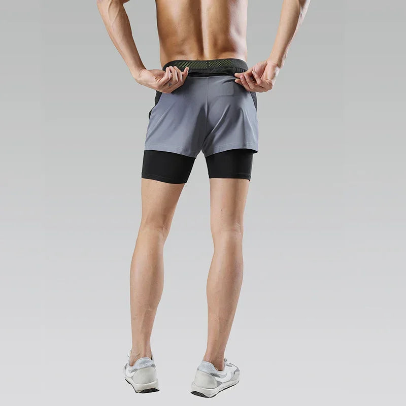Person wearing a two-tone athletic shorts on a plain background