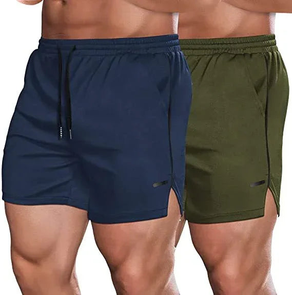 Two pairs of athletic shorts, one navy and one green, on a plain background.