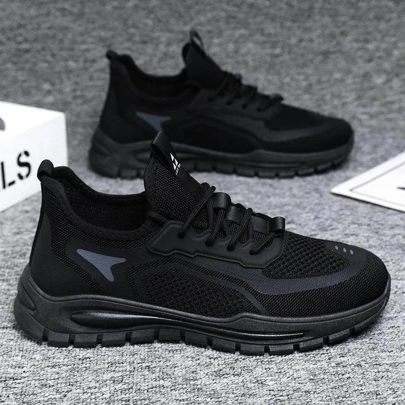 Black athletic shoes on a gray textured surface