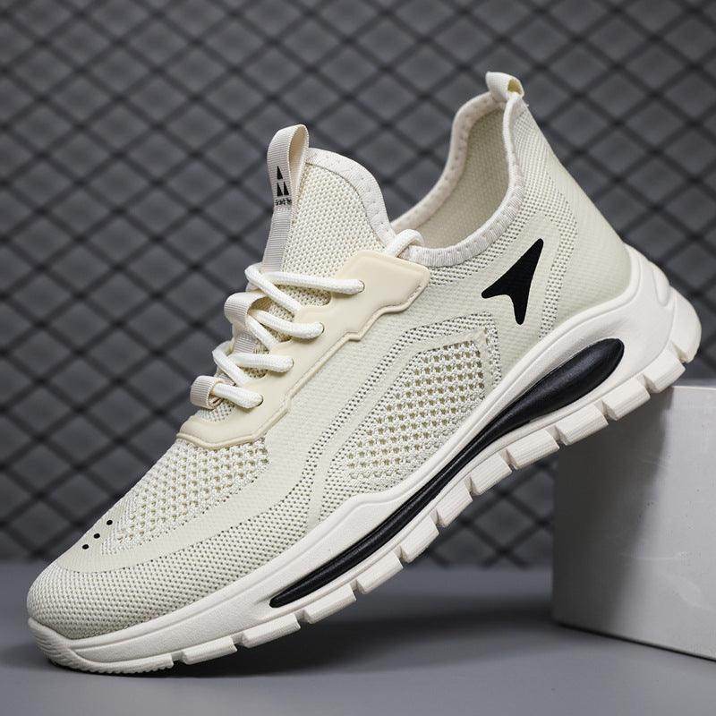 White athletic shoe with black sole and logo on a gray background