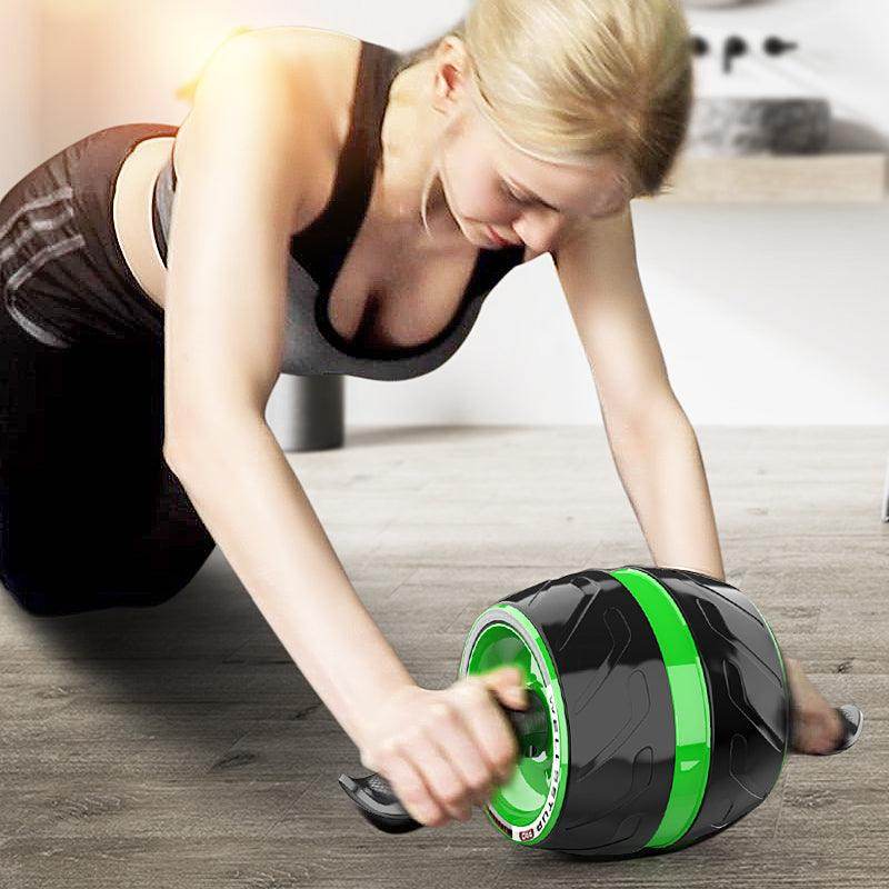 Woman using an ab roller on a wooden floor