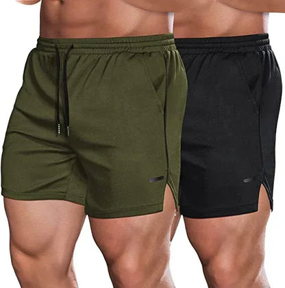 Two pairs of athletic shorts, one green and one black, on a plain background.