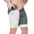 Person wearing a gray and white athletic shorts with a white background