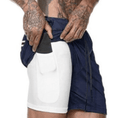 Person wearing navy and white shorts with a white background