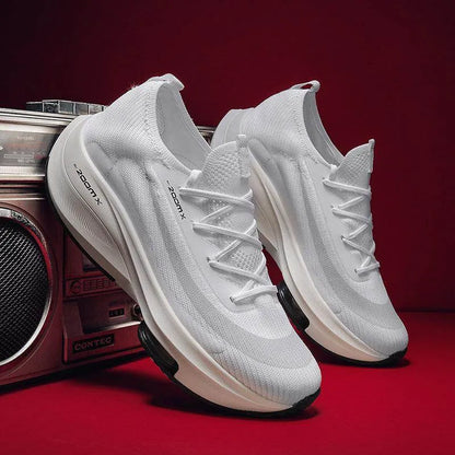 White sneakers with black soles on a red background