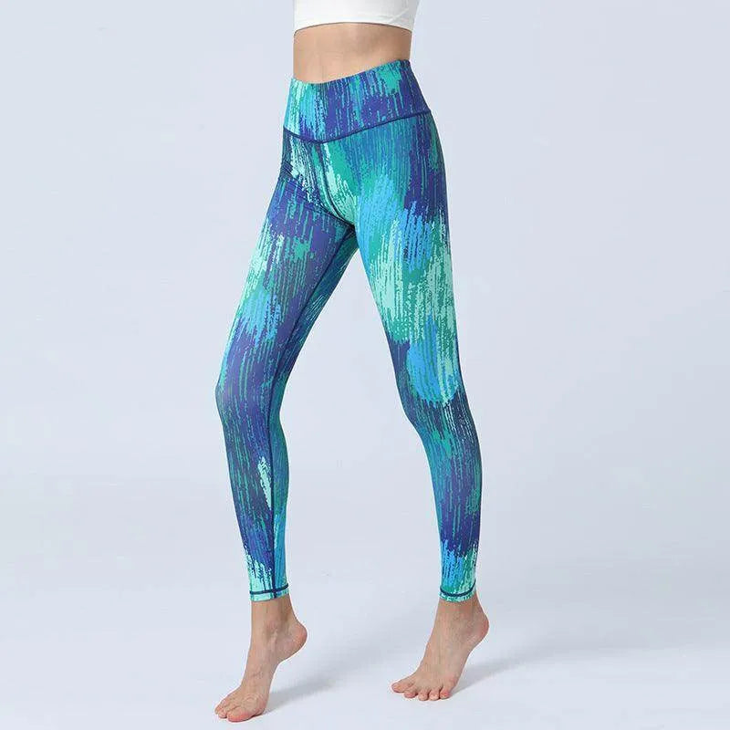 Blue and green patterned leggings worn by a person on a light gray background