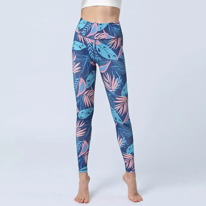 Blue leggings with pink and green leaf pattern on a white background