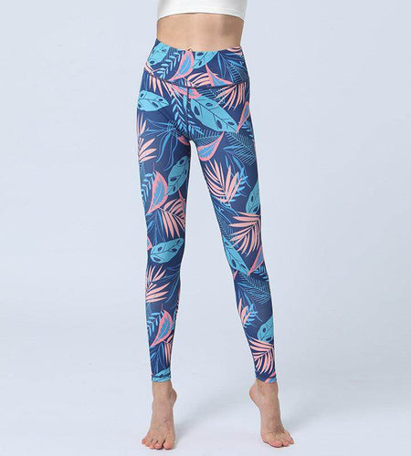 Blue leggings with pink and green leaf pattern on a white background