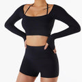 Black long-sleeve crop top and shorts set on a white background