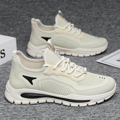 White running shoes with a black logo on a gray surface
