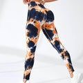 Tie-dye leggings with orange and blue pattern on a white background
