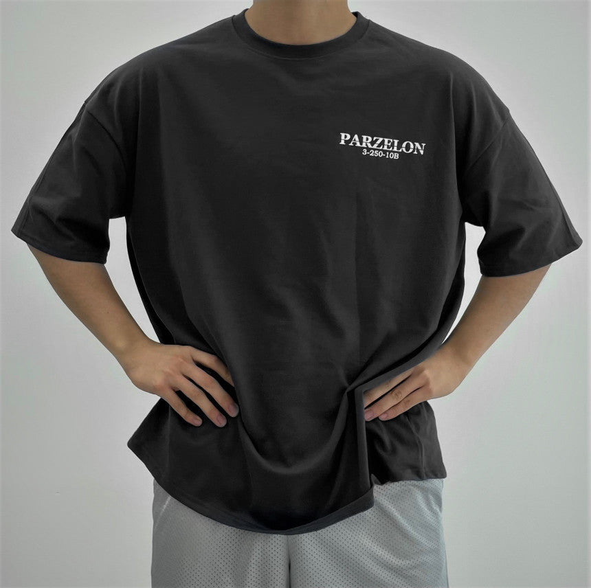 Person wearing a black t-shirt with 'PARZELON' branding on a plain background