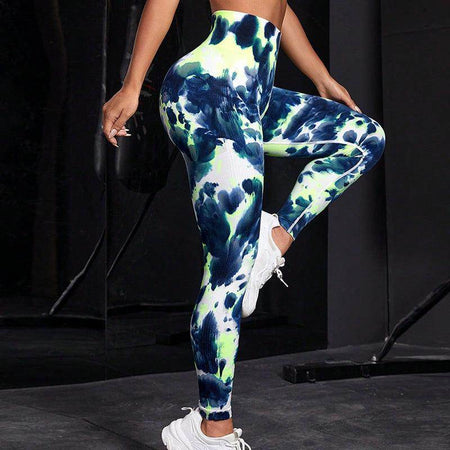Person wearing tie-dye leggings with a black background