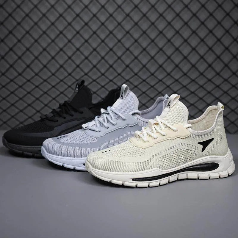 Three pairs of sneakers in black, beige, and gray on a dark background
