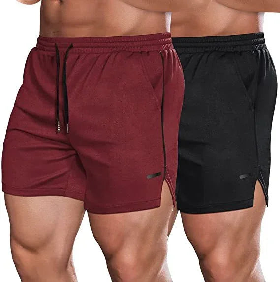 Two pairs of men's shorts, one maroon and one black, on a plain background.